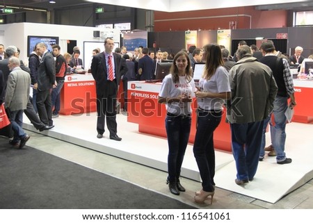 MILAN, ITALY - OCTOBER 17: People visit technology products exhibition area at SMAU, international fair of business intelligence and information technology October 17, 2012 in Milan, Italy.