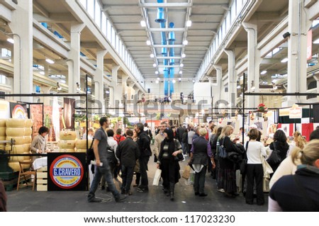 TORINO, ITALY - OCTOBER 24: People visit local and international food stands at Salone del Gusto, international fair of tastes and slow food on October 24, 2010 in Torino, Italy.