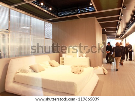 MILAN - APRIL 17: People visit interior design pavilions exhibition area of Salone del Mobile, annual international furnishing accessories exhibition on April 17, 2012 in Milan, Italy.