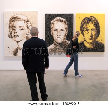 MILAN APRIL 08 People look at paintings galleries during MiArt international exhibition of modern and contemporary art on April 08 2011 in Milan Italy MILAN APRIL 08 People look at paintings galleries during MiArt international exhibition of modern and contemporary art on April 08 2011 in Milan Italy