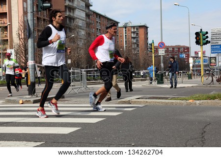 MILAN - APRIL 07: People running on the city streets during Milano City Marathon on April 07, 2013 in Milan, Italy.