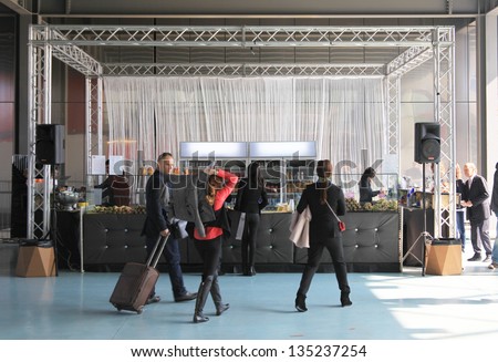 MILAN - APRIL 10: People take a break lunch during Salone del Mobile, international home furnishing and architecture design exhibition April 10, 2013 in Milan, Italy.