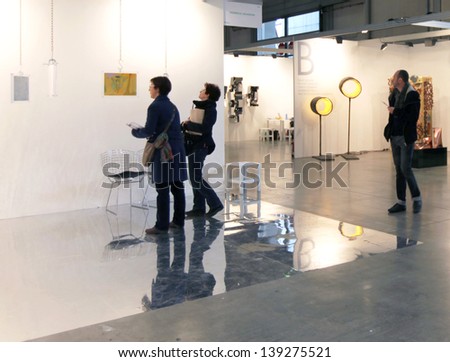 MILAN - APRIL 07: People look at paintings gallery at MiArt, international exhibition of modern and contemporary art April 07, 2013 in Milan, Italy.