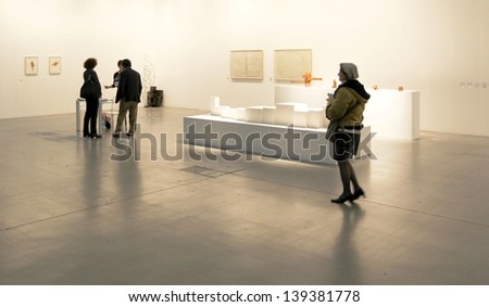 MILAN - APRIL 07: People look at paintings at MiArt, international exhibition of modern and contemporary art April 07, 2013 in Milan, Italy.
