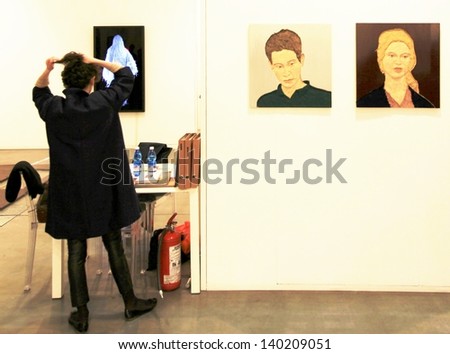 MILAN - APRIL 07: A woman at paintings gallery during MiArt, international exhibition of modern and contemporary art April 07, 2013 in Milan, Italy.