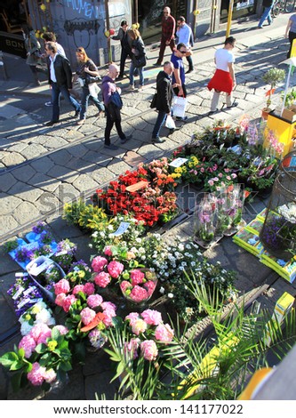MILAN, ITALY - APRIL 14: People look for flowers during the annual Flowers Market in the fashion and culture Navigli area April 14, 2013 in Milan, Italy.