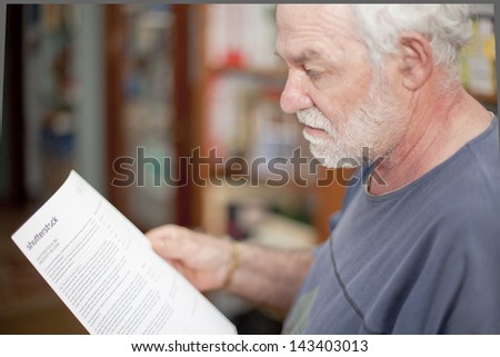 MILAN, ITALY - JUNE 20: A man reads the model release declaration before the photo shooting session for Shutterstock on June 20, 2013 in Milan, Italy.