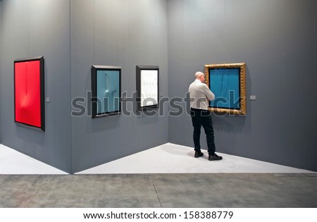 MILAN - APRIL 08: Man look at paintings during MiArt, international exhibition of modern and contemporary art on April 08, 2011 in Milan, Italy