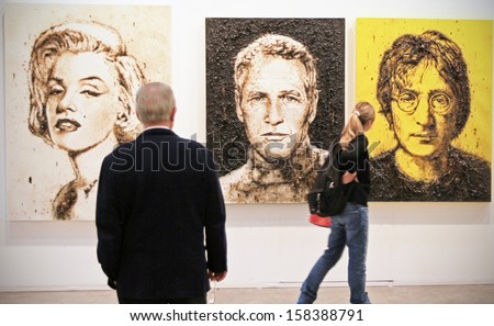 MILAN - APRIL 08: Women look at paintings representing Marilyn Monroe, Paul Newman  and John Lennon at MiArt, international exhibition of modern and contemporary art on April 08, 2011 in Milan, Italy
