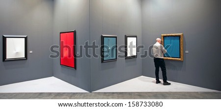 MILAN - APRIL 08: Man looks at paintings galleries during MiArt, international exhibition of modern and contemporary art on April 08, 2011 in Milan, Italy