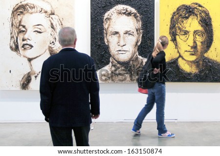 MILAN, ITALY - APRIL 08: People look at Monroe, Newman and Lennon art portraits during MiArt, international exhibition of modern and contemporary art on April 08, 2011 in Milan, Italy