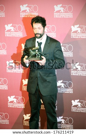 VENICE, ITALY - SEPTEMBER 07, 2013: Noaz Deshe poses with the Lion won for movie White Shadow during the 70th Venice International Film Festival.