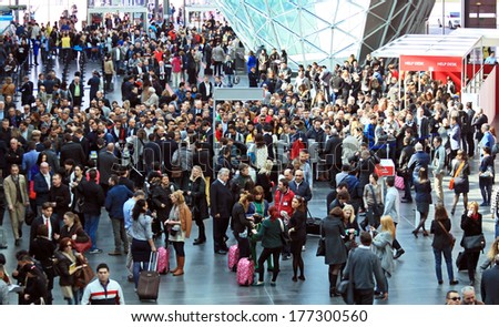 MILANO, ITALY - APRIL 10, 2013: People crowd at the entrance Salone del Mobile, international furnishing accessories exhibition at Rho Fiera Center in Milano, Italy.