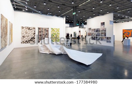 MILANO, ITALY - APRIL 07, 2013: Looking at paintings gallery at MiArt, international exhibition of modern and contemporary art April 07, 2013 in Milan, Italy.