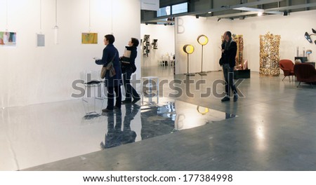 MILANO, ITALY - APRIL 07, 2013: People look at paintings gallery at MiArt, international exhibition of modern and contemporary art April 07, 2013 in Milan, Italy.