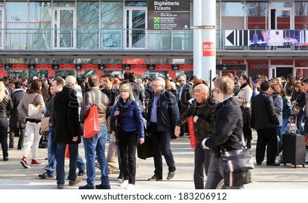 MILANO, ITALY - APRIL 10, 2013: People crowd enter Salone del Mobile, international furnishing accessories exhibition at Rho Fiera Center in Milano, Italy.