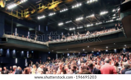 Crowd in a theater, intentionally blurred post production background