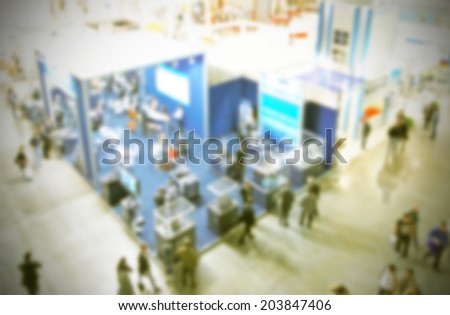 Trade show background, intentionally blurred post production, vintage yellow filtered