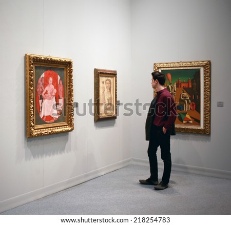 MILANO, ITALY - MARCH 27, 2010: Man looks at paintings galleries during MiArt, international exhibition of modern and contemporary art in Milano, Italy