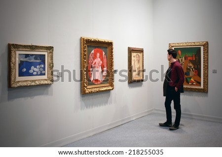MILANO, ITALY - MARCH 27, 2010: Man looks at paintings galleries during MiArt, international exhibition of modern and contemporary art in Milano, Italy