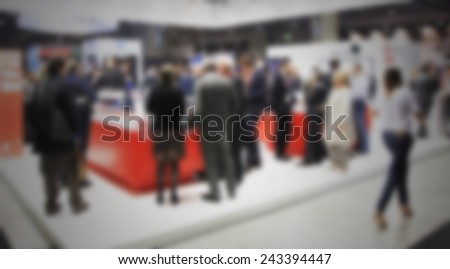 People crowd, trade show. Intentionally blurred post production.