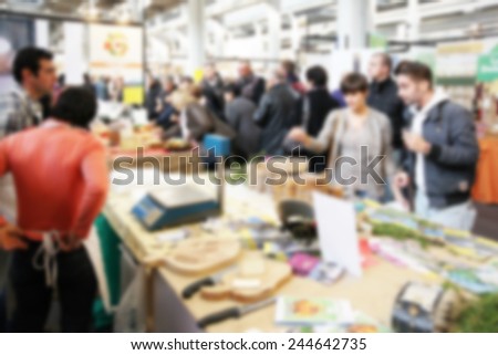 People at food show. Intentionally blurred post production.