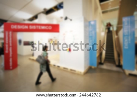 Woman enters trade show. Intentionally blurred post production.