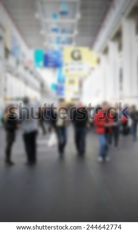 Trade show, people walk. Intentionally blurred post production.