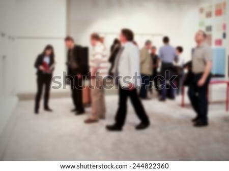 People visit a show. Intentionally blurred post production.