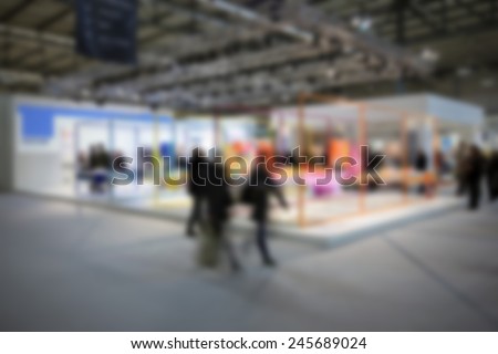 People visit trade show, generic background, humans not recognizable. Intentionally blurred post production.