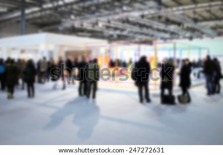 Trade show people. Intentionally blurred post production background.