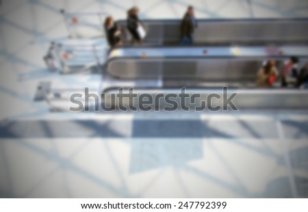 People on a tapis roulant, trade show background.