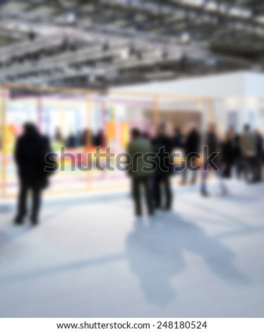 Trade show people. Intentionally blurred background.