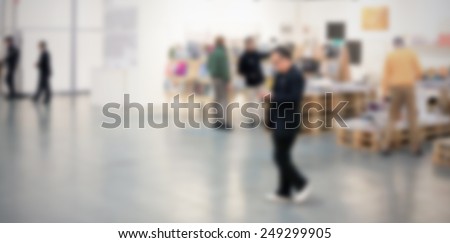 Art gallery generic background. Intentionally blurred post production, humans and location not recognizable.