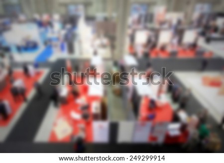 Trade show, panoramic view. Intentionally blurred post production, humans and location not recognizable.
