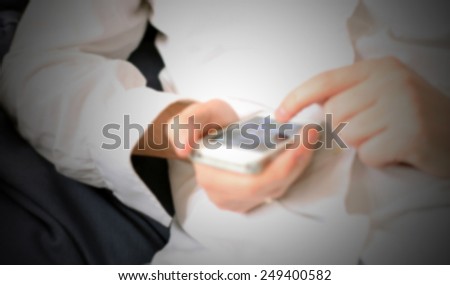 Man browses with his smart phone. Intentionally blurred post production background.