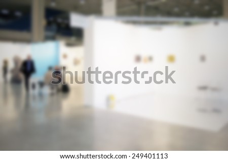 Exhibition art gallery background, location, works and people not recognizable. Intentionally blurred post production background.
