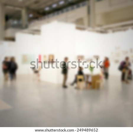 People visit an art gallery, generic background. Intentionally blurred post production background.