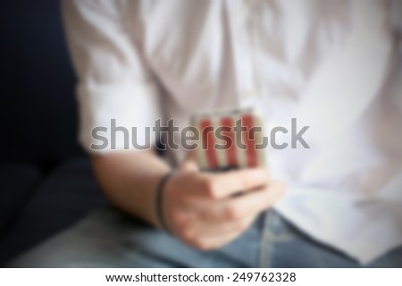 Man and his smart phone. Intentionally blurred editing post production background.