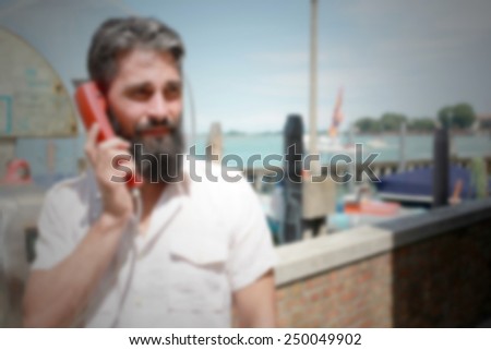 Hipster on cable phone. Intentionally blurred editing post production background.
