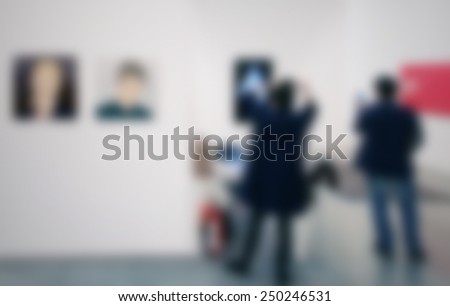 People visit an art gallery, generic background. Intentionally blurred editing post production background.