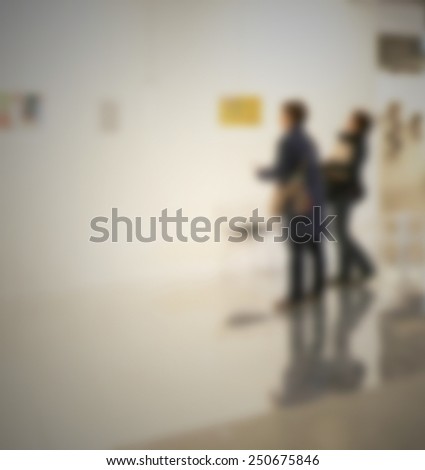 People at art gallery. Intentionally blurred editing post production.