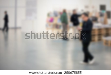 Man walks in a art gallery. Intentionally blurred editing post production.