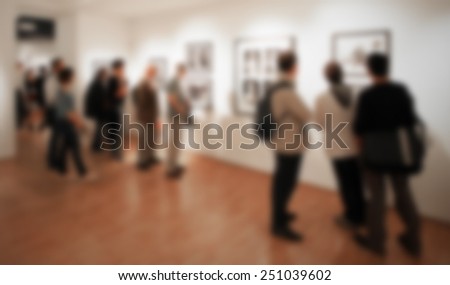 Photography gallery, people background. Intentionally blurred editing post production. Location, works and people not recognizable.