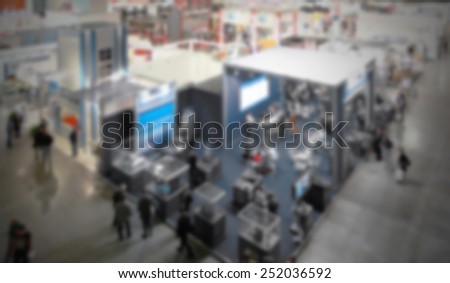 Trade show generic background. Intentionally blurred editing post production. People, works and location not recognizable.
