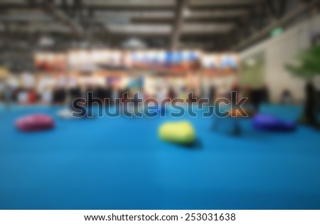 Blurred people, trade show generic background. Intentionally blurred editing post production.