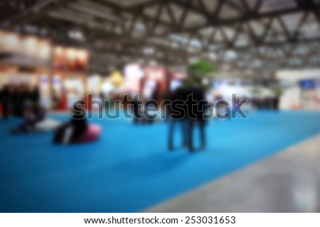 People walking, trade show generic background. Intentionally blurred editing post production.
