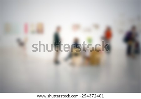People at art gallery, generic background. Intentionally blurred editing post production.