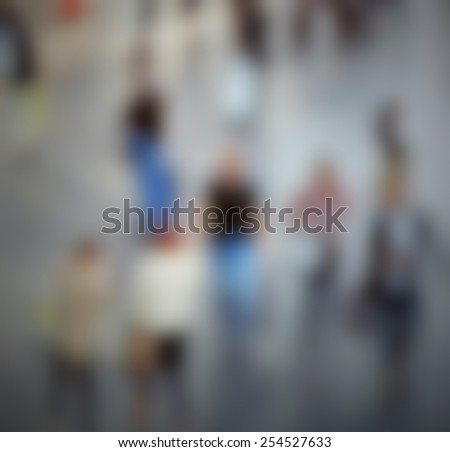 People crowd at trade show, generic background. Intentionally blurred editing post production.