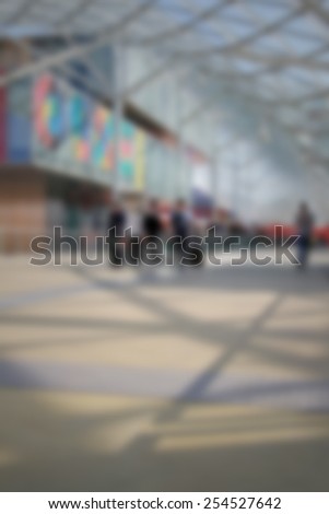People arriving at trade show, generic background. Intentionally blurred editing post production.